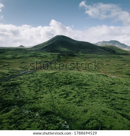 Iceland nature landscape, aerial view from drone. Volcanic green moss lava field and black mountain from above