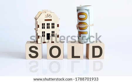 Wooden blocks with the word For SOLD Real estate concept. Rent apartment. Property.