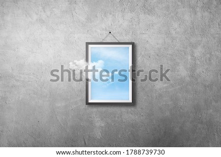Abstract image of White cloud flying out from picture or photo frame that hanging on concrete wall grunge texture background.