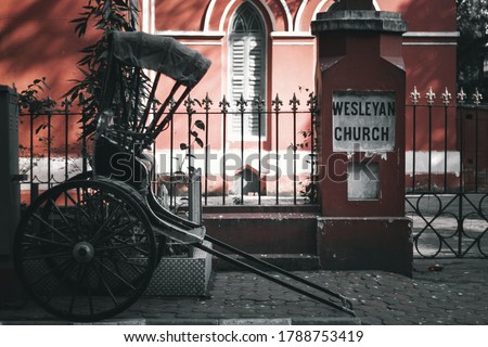Hand-pulled Rickshaw or Tanga Rickshaw in front of the Wesleyan Church, Kolkata Royalty-Free Stock Photo #1788753419