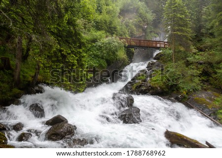 The "Riesachfälle" waterfall and a bridge near Schaldming, Styria, Austria on a rainy day