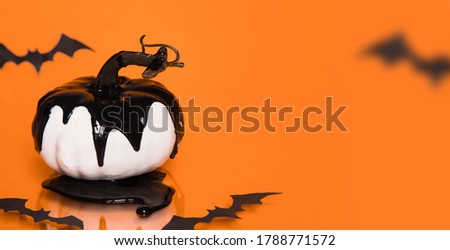 Happy Halloween composition. white pumpkins in black on orange background, copy space for text