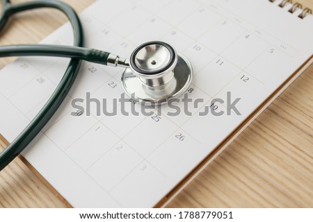 Stethoscope with calendar page date on wood table background doctor appointment medical concept Royalty-Free Stock Photo #1788779051