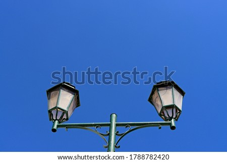Old-style lantern on the blue sky background. Europe in the sky of Portugal lantern and abstract illumination