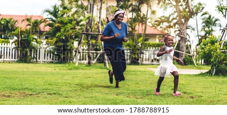 Portrait of enjoy happy love black family african american mother and little african girl child smiling running and having fun moments good time in summer park at home