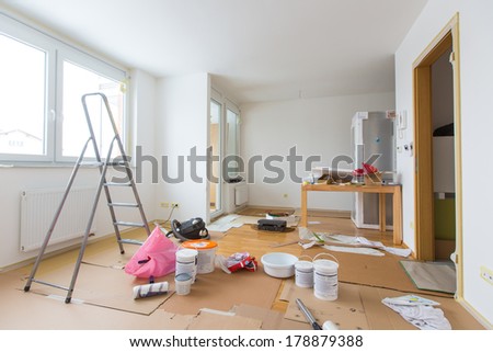 Home renovation in room full of painting tools Royalty-Free Stock Photo #178879388