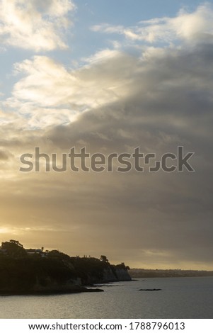 The sunset over the Auckland coastline