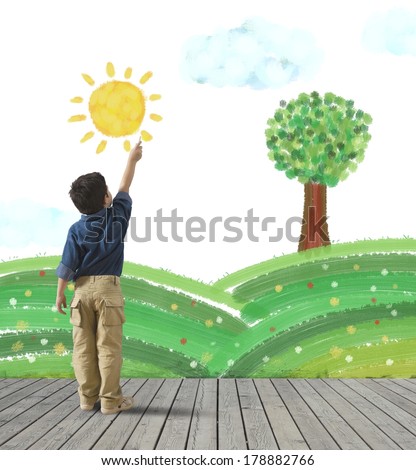 Young child draws a green panorama in a wall