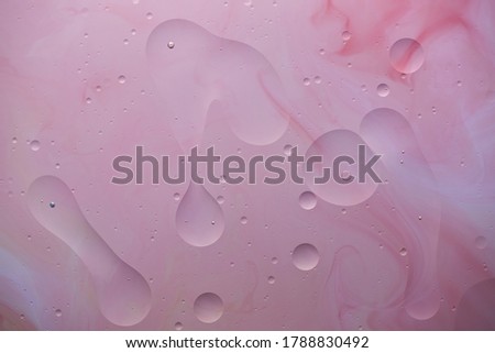 Current collection of brilliant backgrounds for your design. Close-up shot of water spots and bubbles on pale pink surface with stains.