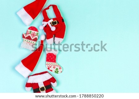 Top view od stylish red Santa hats on colorful background. Merry Christmas concept with copy space.