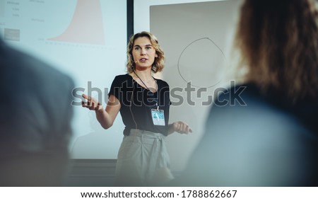 Woman presenting her idea to colleagues in meeting. Businesswoman public speaking in a conference meeting. Royalty-Free Stock Photo #1788862667