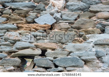 Stone and rock wall background. Vintage gray green color stone wall background and texture, Traditional greek island architecture and construction