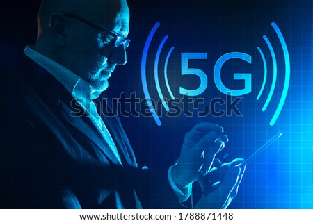 5g logo next to a man with a smartphone. 5g wireless networks. High-speed Internet 5G. High data transfer speed.