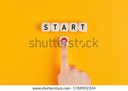 The word start on wooden cubes with a male hand pressing the start button. To make a new start in life, business, education or career concept.

 Royalty-Free Stock Photo #1788902324
