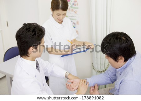 Nurse and doctor giving a treatment to the male patient