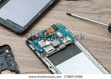 Smartphone repair concept. The inside of the smartphone. Electronic repairing. 