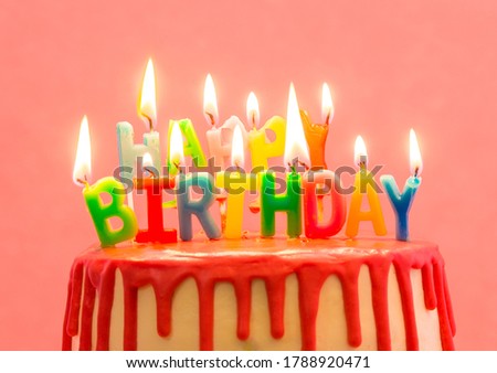 Happy birthday candles. Cake with red chocolate decoration on pink background. Bright candles. Happy birthday. Sweet and tasty dessert
