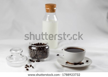 Black coffee and coffee beans on the table in the morning