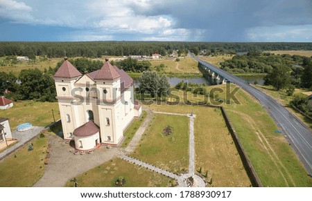 Brown church in town landscape with bridge aerial view
