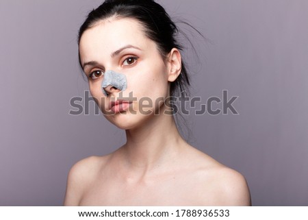 woman with blackhead plaster on nose, home skin care