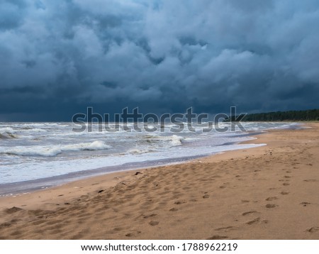 Sea beach during a thunderstorm with large dark rain clouds, soft picture