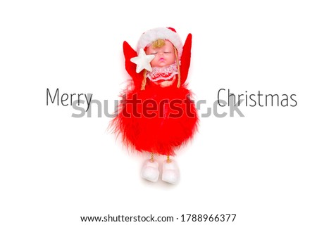 Flat lay composition Angel with wings
in red clothes and hat isolated on white background Top view Xmas Holiday card Creative Merry Christmas concept with text