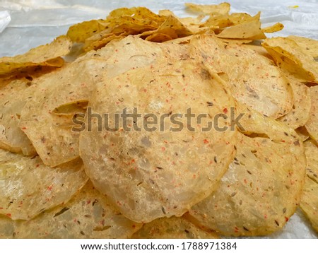 homemade crunchy and delicious indian aaloo zeera papad(chips) closeup picture