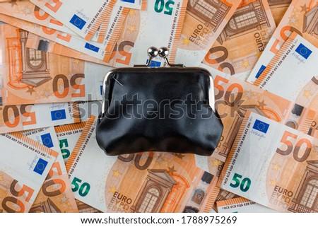 Financial concept with closed purse on banknote background flat lay. 