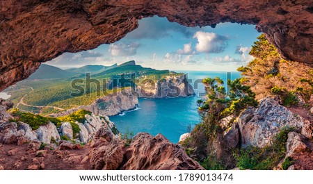 Astonishing summer view of Caccia cape from the small cave in the cliff. Fabulous morning scene of Sardinia island, Italy, Europe. Aerial Mediterranean seascape. Beauty of nature concept background. Royalty-Free Stock Photo #1789013474