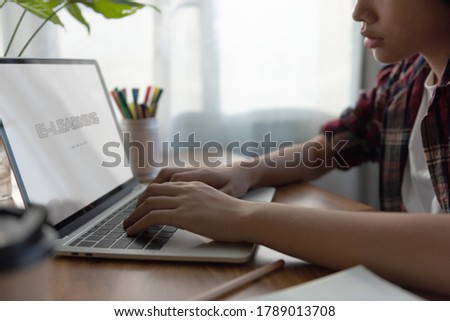 Female student using laptop computer at home for learning global connectivity technology and studying through online E-learning System concept. Preparing Students for Life and Work. Mockup screen. Royalty-Free Stock Photo #1789013708
