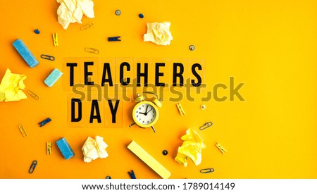 Text TEACHERS DAY on yellow background with school supplies and alarm clock. Back to school. Holiday concept