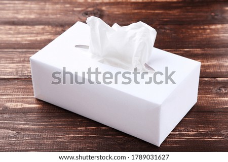Paper napkin box on brown wooden table
