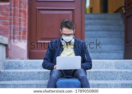 Male student in the campus wearing maskk due to coronavirus pandemic