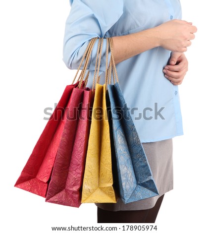 Young woman holding colorful shopping bags in  her hand, isolated on white