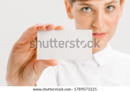  close-up portrait of a young businesswoman with Blank Business Card. High quality photo
