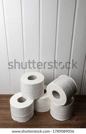 some rolls of toilet paper on a wooden table