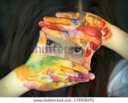 Girl hands shaped in viewfinder or frame 