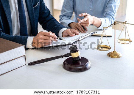 Businesswoman and Male lawyer or judge consult and conference having team meeting with client at law firm in office, Law and Legal services concept. Royalty-Free Stock Photo #1789107311