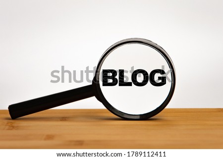 Focused on business concept. Magnifier glass with word blog on wooden table. Business concept. Search idea