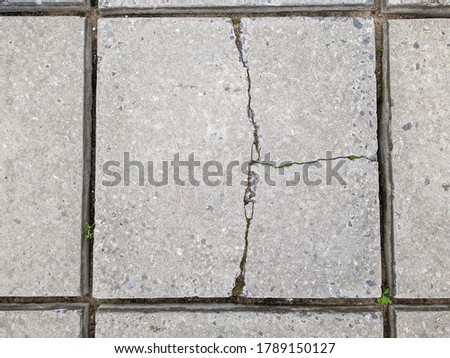 old and grey concrete slab with cracks in daytime