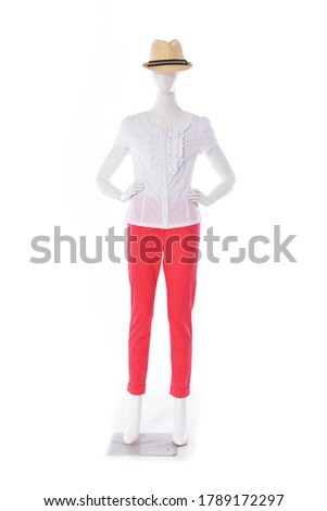 female in blouse clothes and orange pants with hat on mannequin —white background

