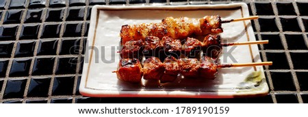 Japanese wagyu beef grilled in white dish or plate on tile table at street food market. Meat barbecue and Famous food in Japan
