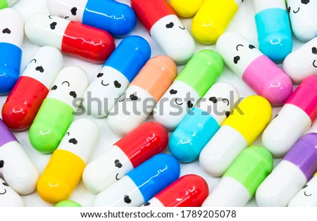 Smiling face colorful capsule medicine against rare diseases. Orphan drugs. Royalty-Free Stock Photo #1789205078