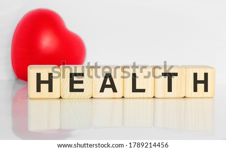 Red heart. Healthcare and Medicine With Media Icons Concept, Wooden Cube From Stack on wooden table Red heart