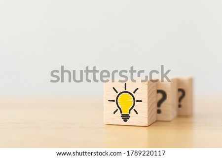 Concept creative idea and innovation. Wooden cube block with light bulb icon and question mark symbol Royalty-Free Stock Photo #1789220117