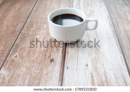 black coffee in white cup from top view