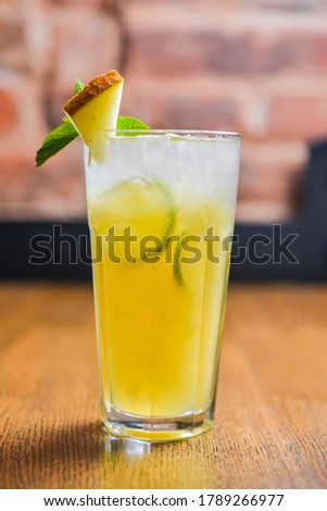 Delicious melon cocktail served in a glass on a rustic wooden table. Seasonal summer beverage, tasty alcohol drink in a bar. Melon juice lemonade.