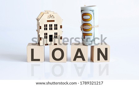 Wooden blocks with the word For LOAN Real estate concept. Rent apartment. Property.