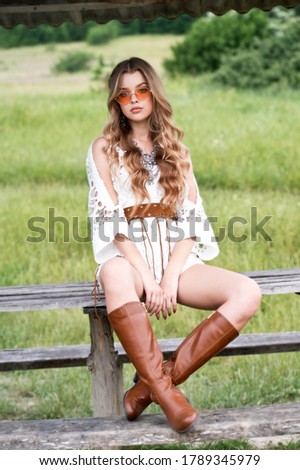 Beautiful girl with long hair. Bride with dream catcher on sunset outdoor. Boho style. Summer time. Series.