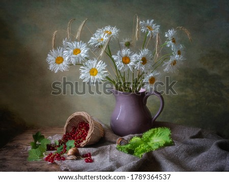 Still life with bouquet of chamomiles and red currant